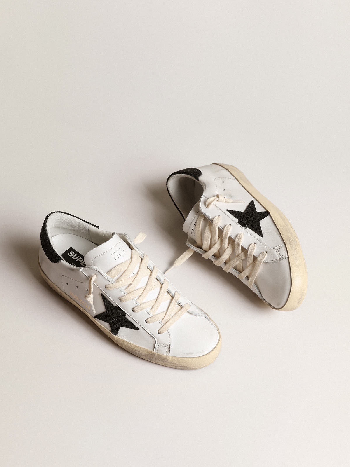 Golden Goose Super-Star with a black Swarovski crystal star