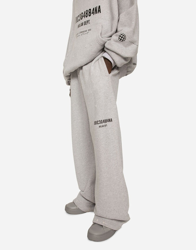 Printed jogging pants with small abrasions 4