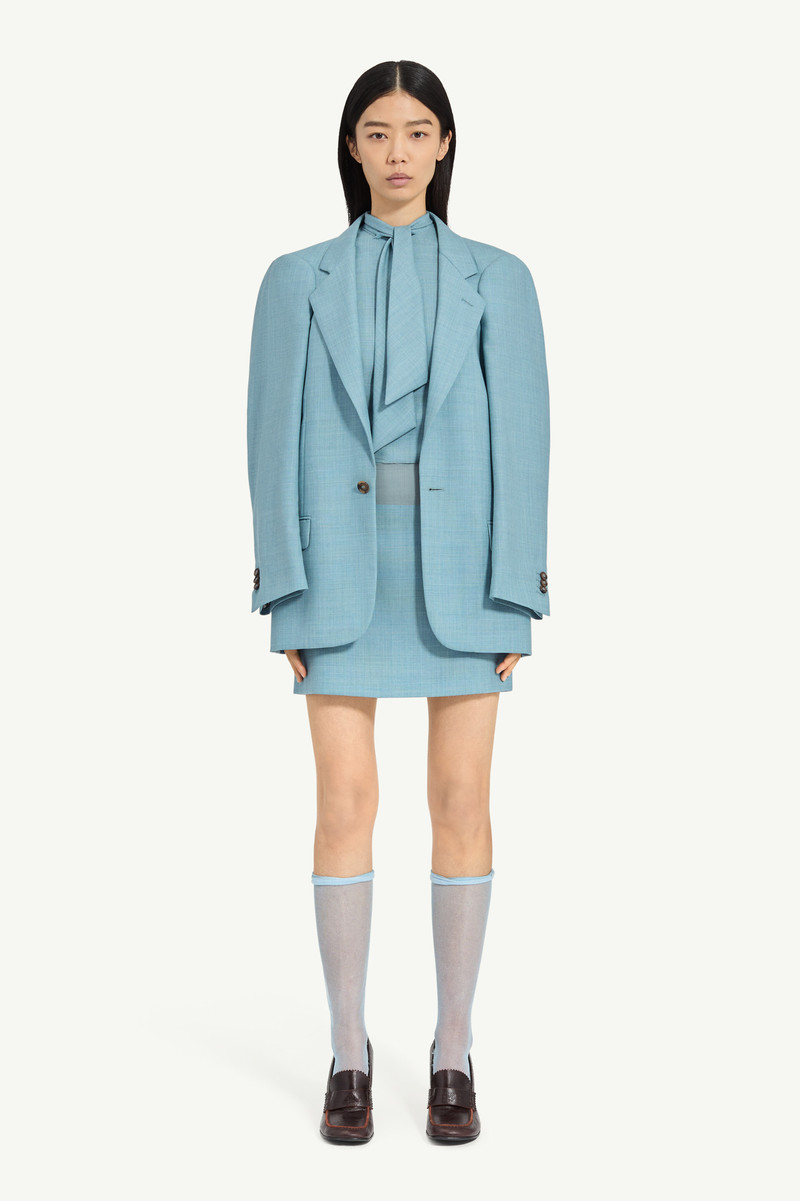 A flattened silhouette reworks classic tailoring by pressing structure into a more two-dimensional f 5