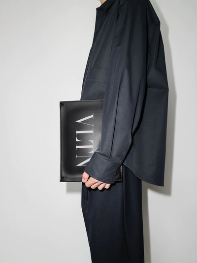 Valentino logo-print clutch bag outlook