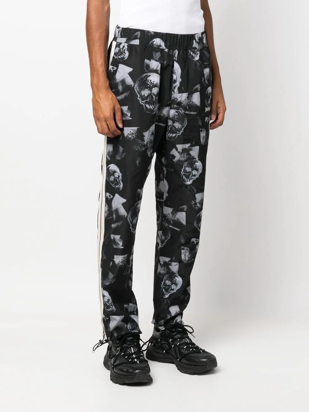 all-over skull-print trousers - 3