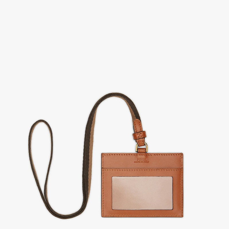 FENDI Fendi Roma name badge with a slot and Pequin ribbon strap. Made of brown leather. Embellished with F outlook