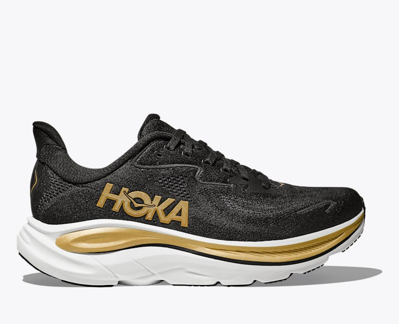 HOKA Women's Clifton 10 Shoes in Black/Gold outlook