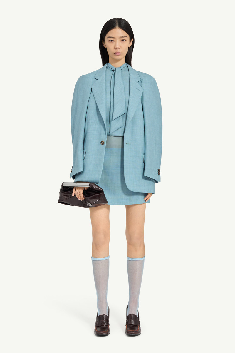 A flattened silhouette reworks classic tailoring by pressing structure into a more two-dimensional f 6