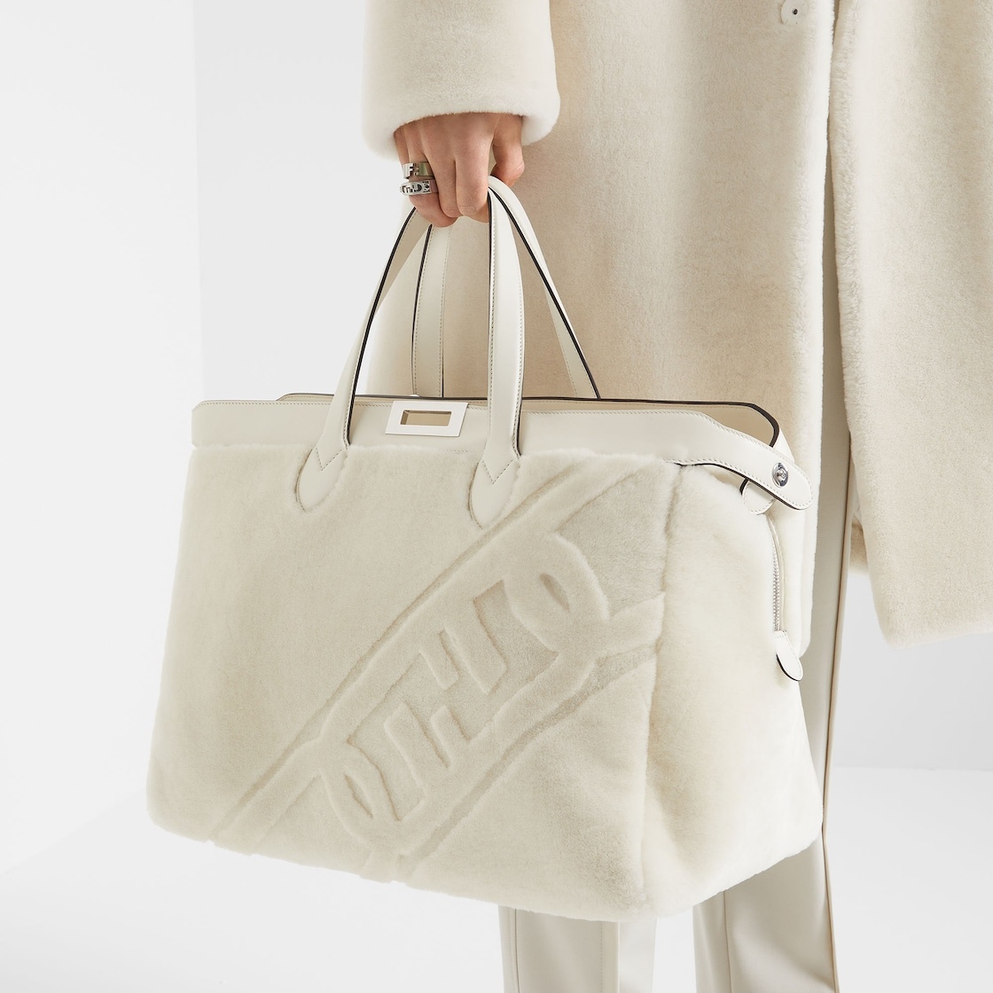 Peekaboo ISeeU Forty8 bag made of soft white sheepskin with an oversized shaved O’Lock motif. Roomy  7