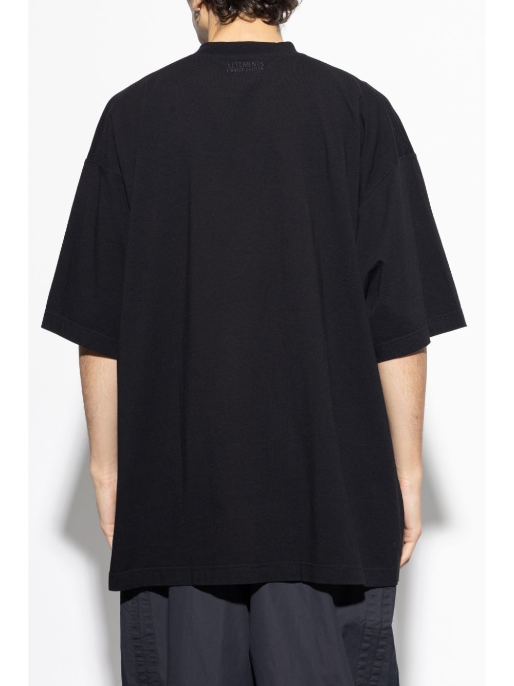 VETEMENTS slogan-print T-shirt | REVERSIBLE