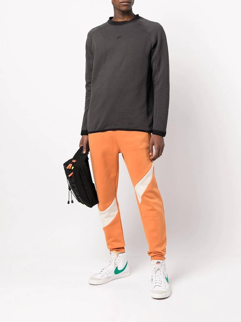 Nike swoosh-print fleece track pants outlook