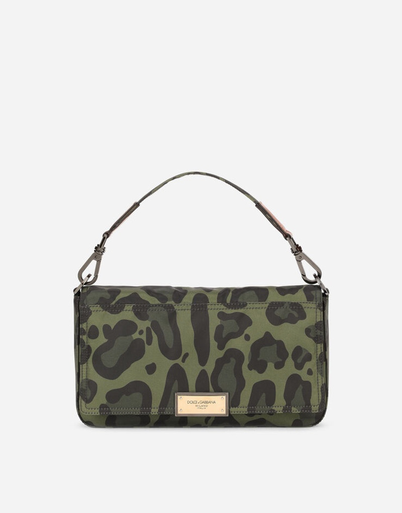 Nylon crossbody bag with leopard print against a green background and branded plate 1