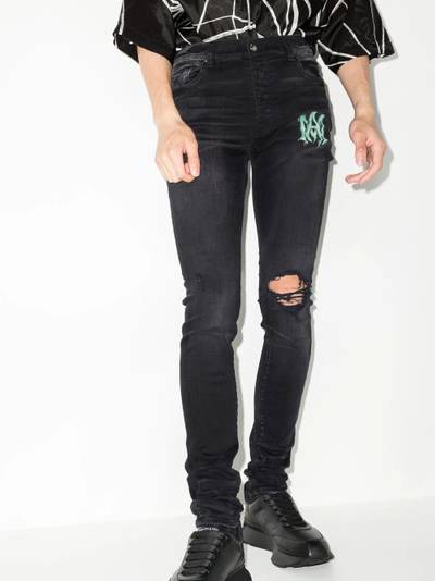 AMIRI Watercolour logo-print skinny jeans outlook