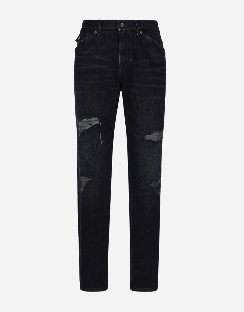 Blue denim jeans with abrasions and rips 1