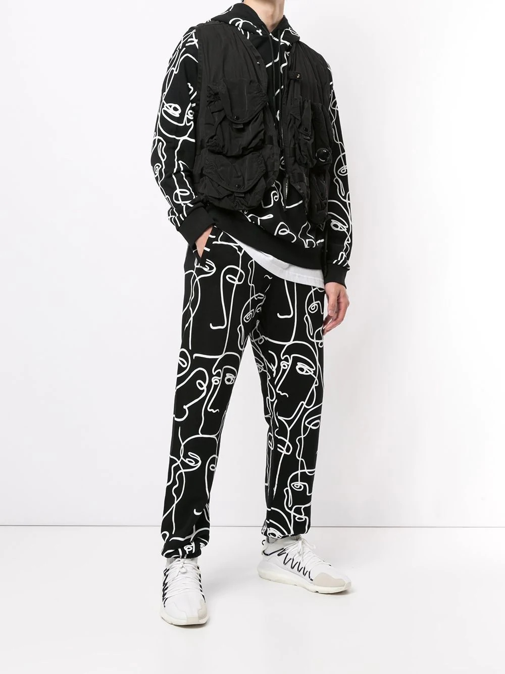 all-over Faces print track pants - 2