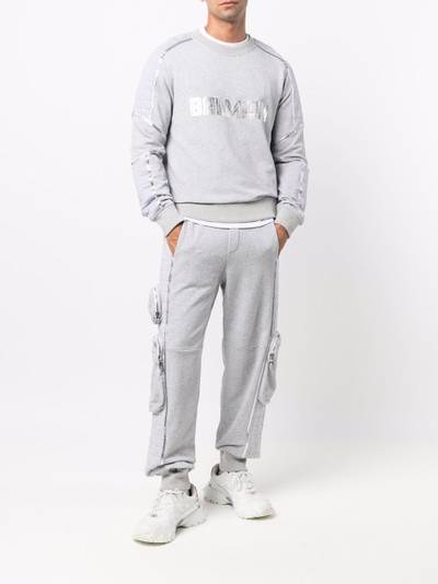 Balmain motif-print toggle-fastening track pants outlook