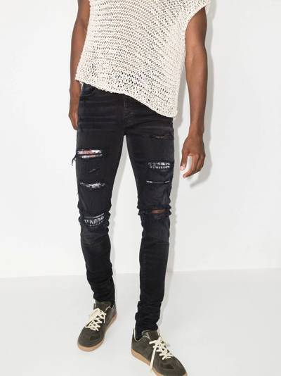 AMIRI Hibiscus art patch skinny jeans outlook