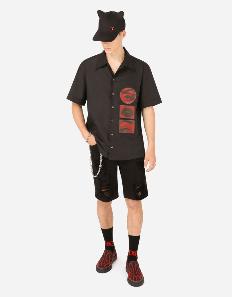 Dolce & Gabbana Black denim shorts with rips and patch embellishment outlook
