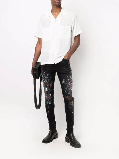 AMIRI paint print distressed skinny jeans outlook