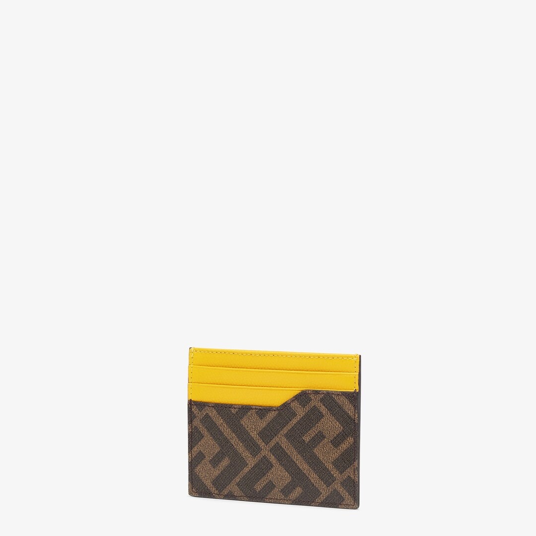 Card holder with central flat pocket and 6 slots. Made of textured fabric with FF motif in brown and 2