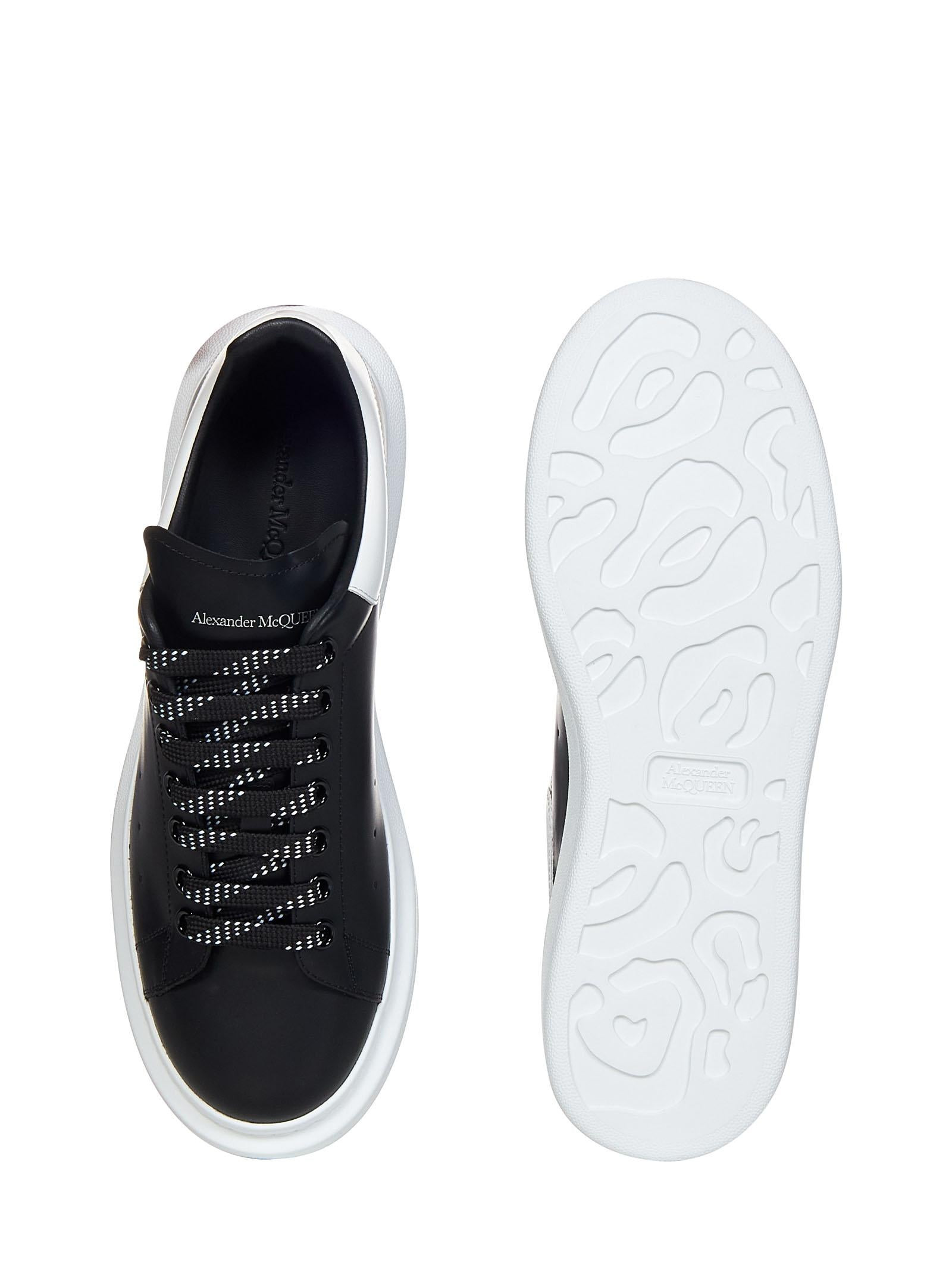 Oversize black smooth leather sneakers with white leather detail on the heel. - 4