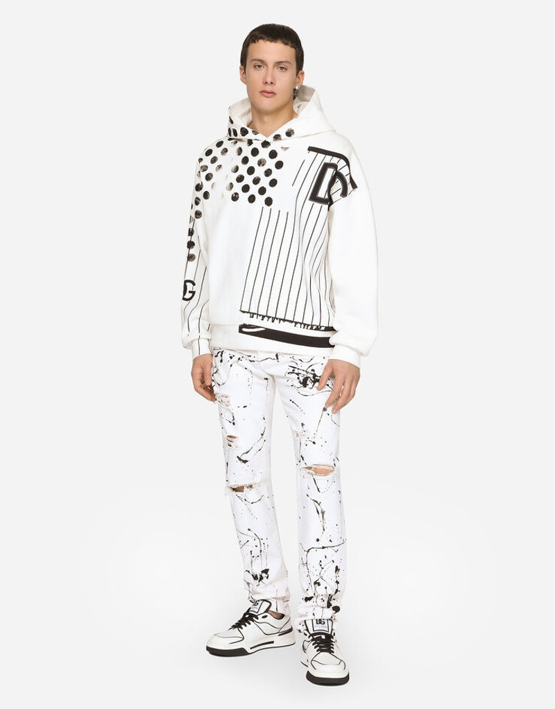 Slim-fit stretch jeans with rips and splash design 1