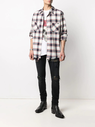 AMIRI distressed skinny jeans outlook