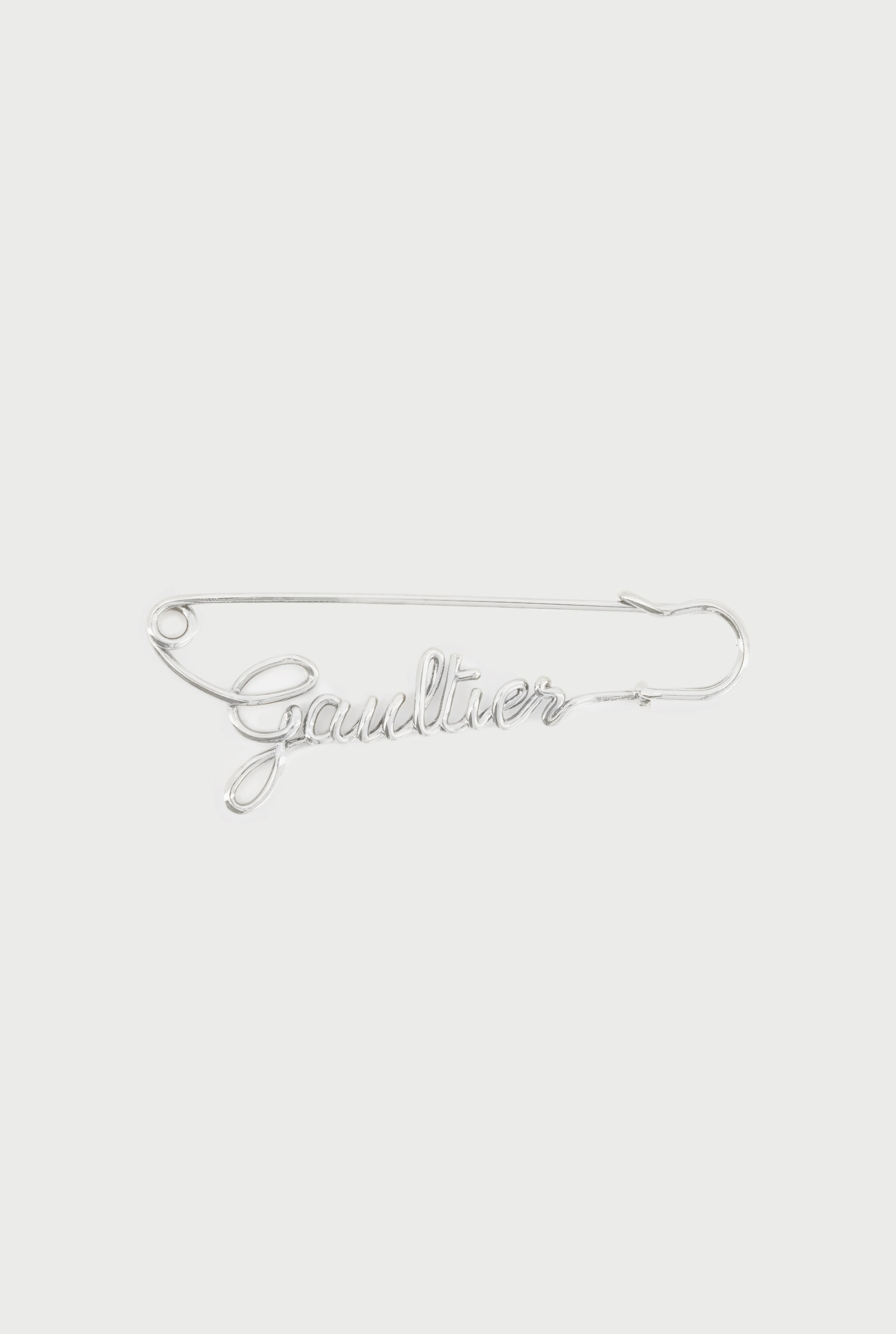 THE SILVER-TONE GAULTIER BROOCH - 1