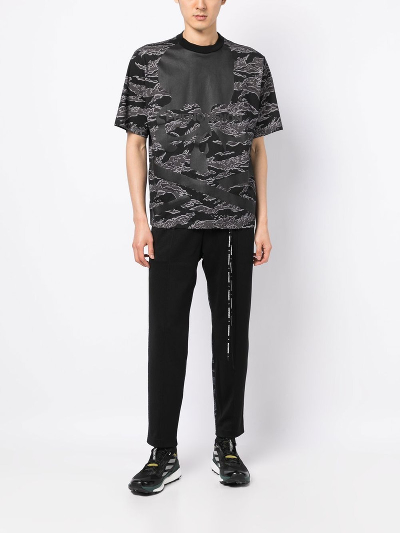 MASTERMIND WORLD camouflage-print track pants outlook