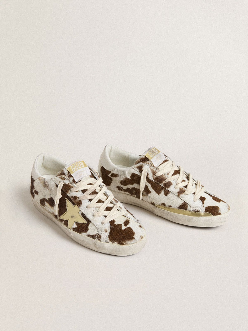 Golden Goose Women’s Super-Star in animal-print pony skin with gold metallic leather star outlook