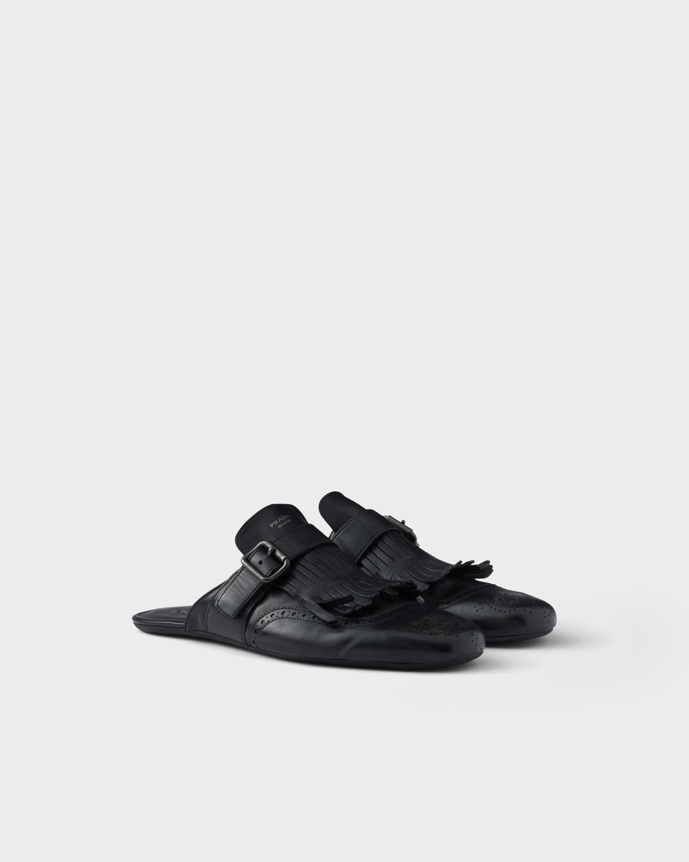 Shuffle antiqued leather mules with buckled strap and fringe - 1