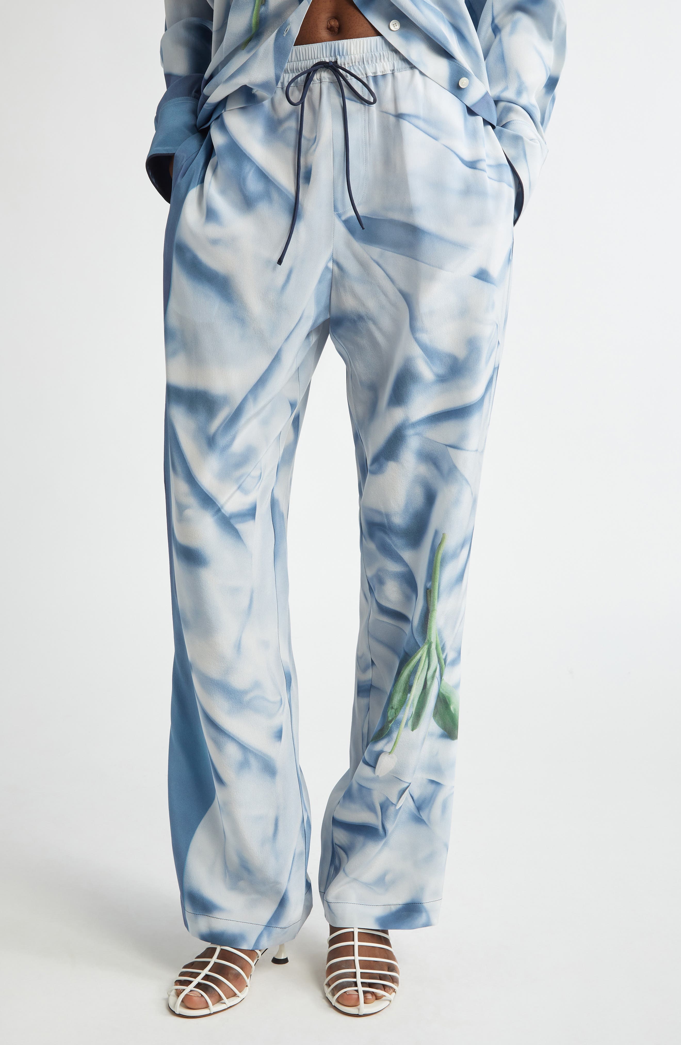 Victoria Beckham Pleat Detail & Flowers Trompe l'Oeil Silk Satin Pants in Satin Flowers Ice Blue at  - 1
