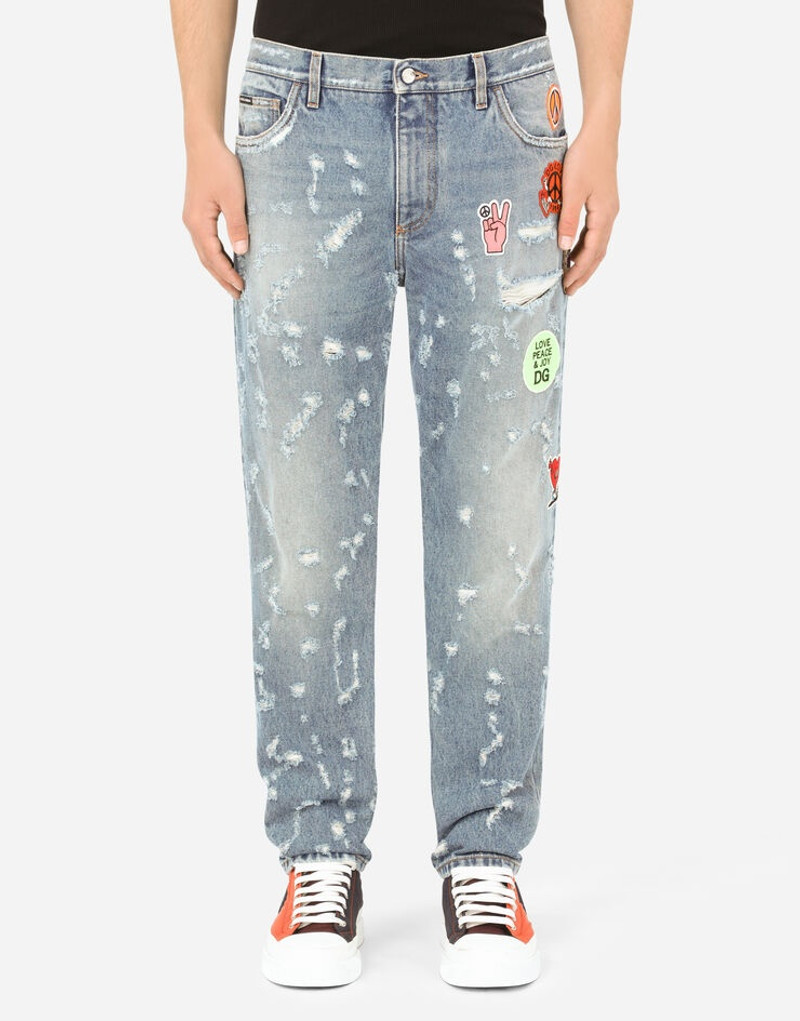Loose light blue jeans with rips and patch detailing 2