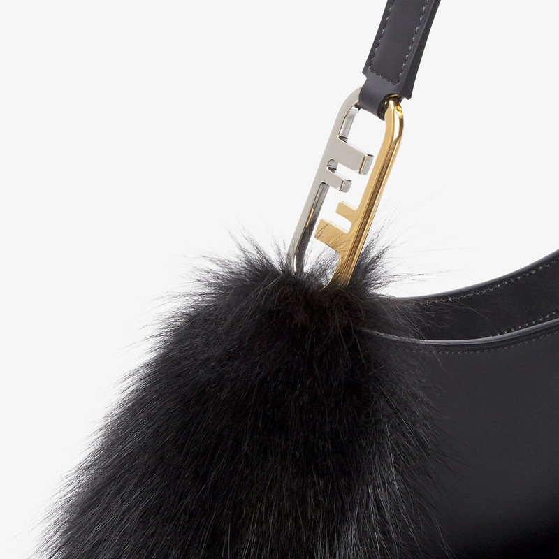 Pouch made of black leather, embellished with tone on tone fox fur and decorated with Fendi Roma let 5