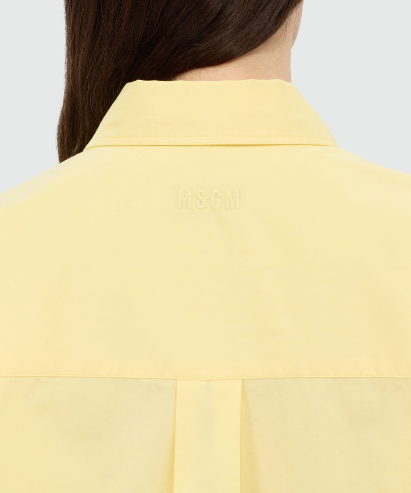 Yellow cotton poplin shirt with asymmetrical detail. 5