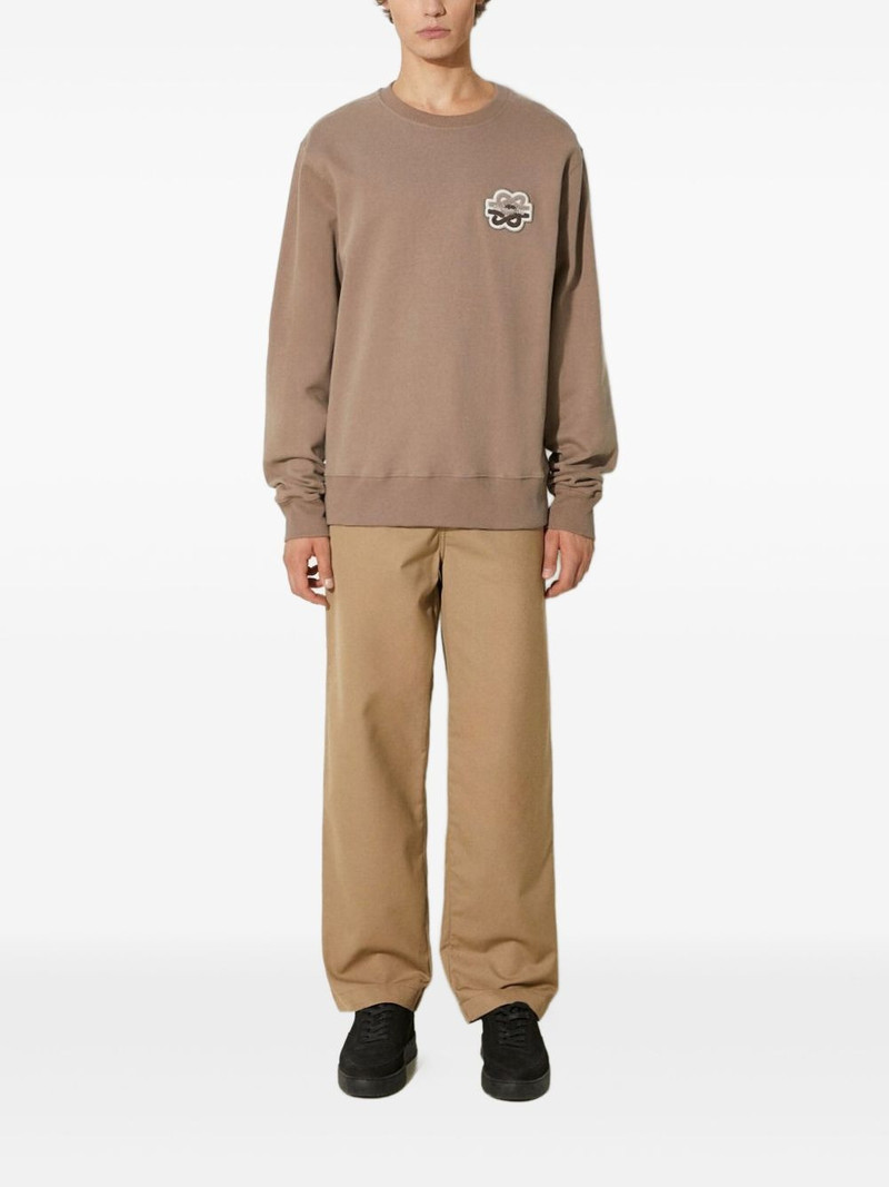 Carhartt WIP flat-front logo-patch trousers outlook