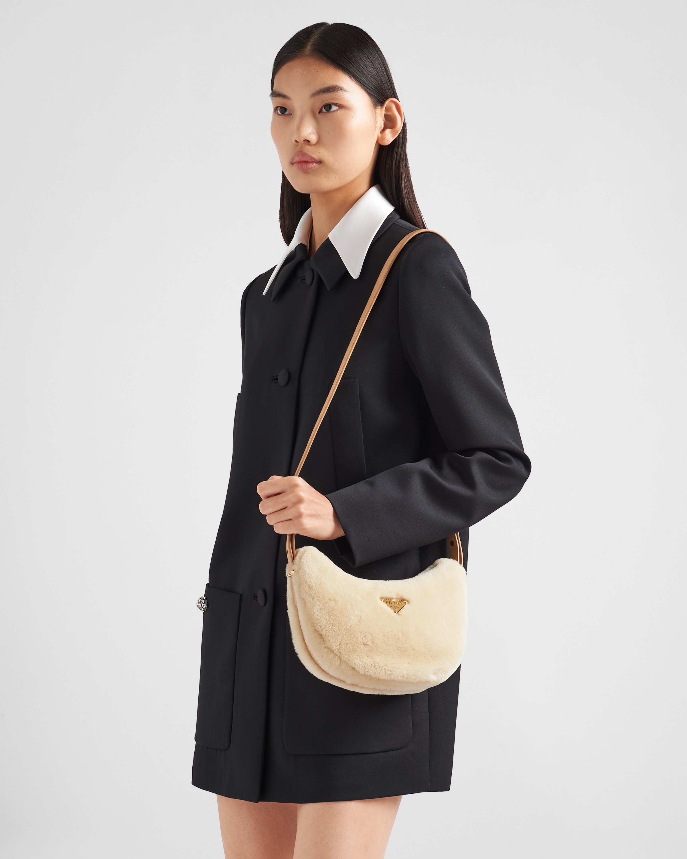 Prada Prada Arqué shearling and leather shoulder bag | REVERSIBLE