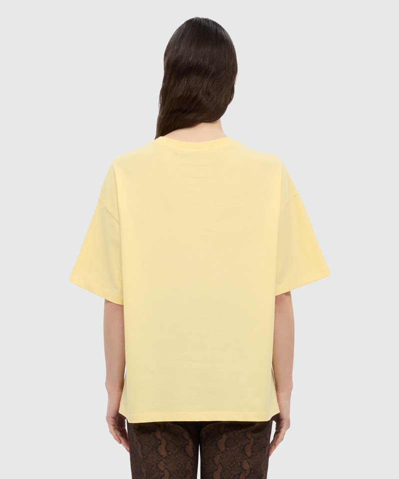 Yellow T-shirt with MSGM graphic print and bow. 3