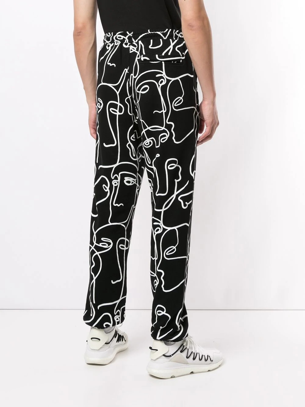 all-over Faces print track pants - 4