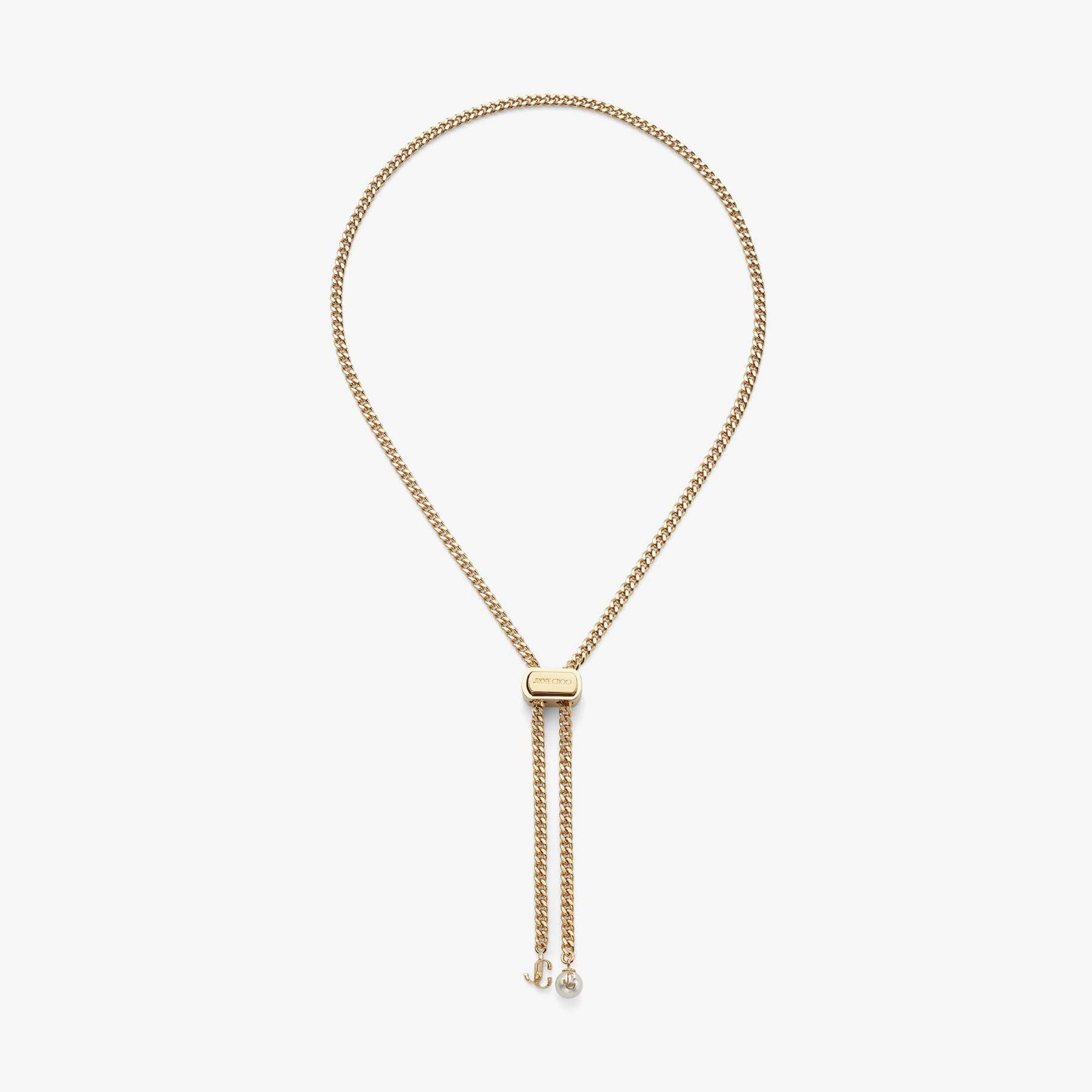 Bon Bon Necklace
Gold-Finish Metal Necklace with Pearl and JC Charm - 1