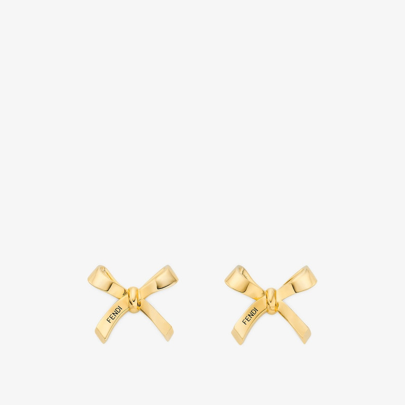 Bow-shaped earrings. Made of metal with a gold finish. Decorated with Fendi lettering enameled in bl 1
