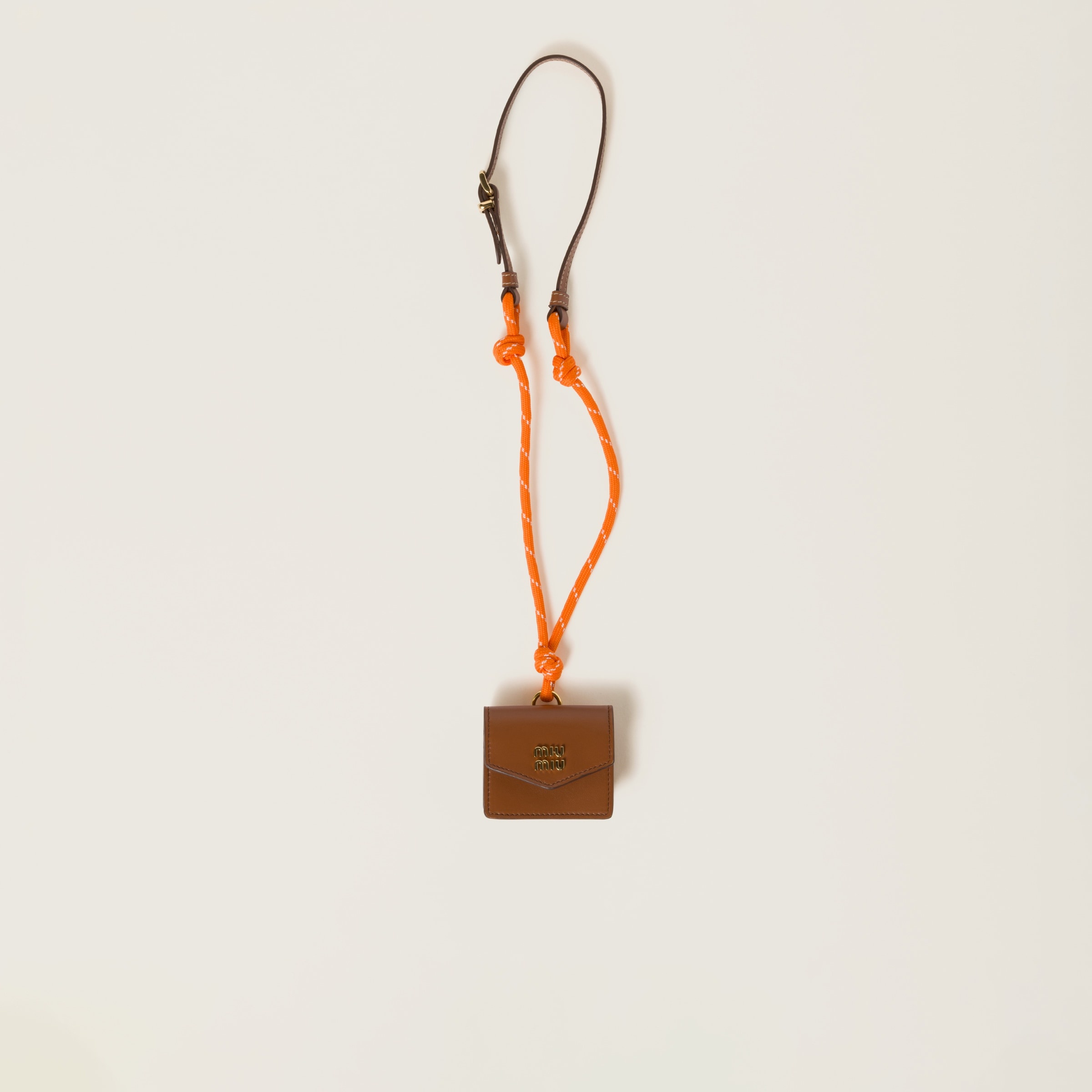 Miu Miu Leather, cord, and metal trick with mini-pouch
