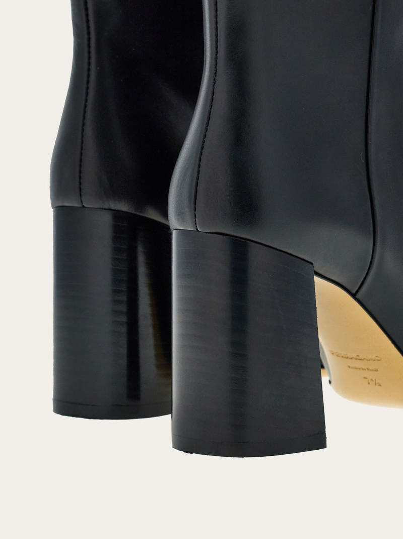 Knee high boot with golden tab 8