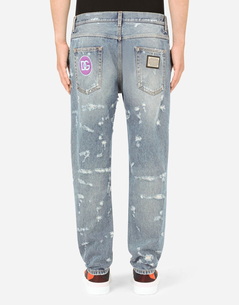 Loose light blue jeans with rips and patch detailing 3