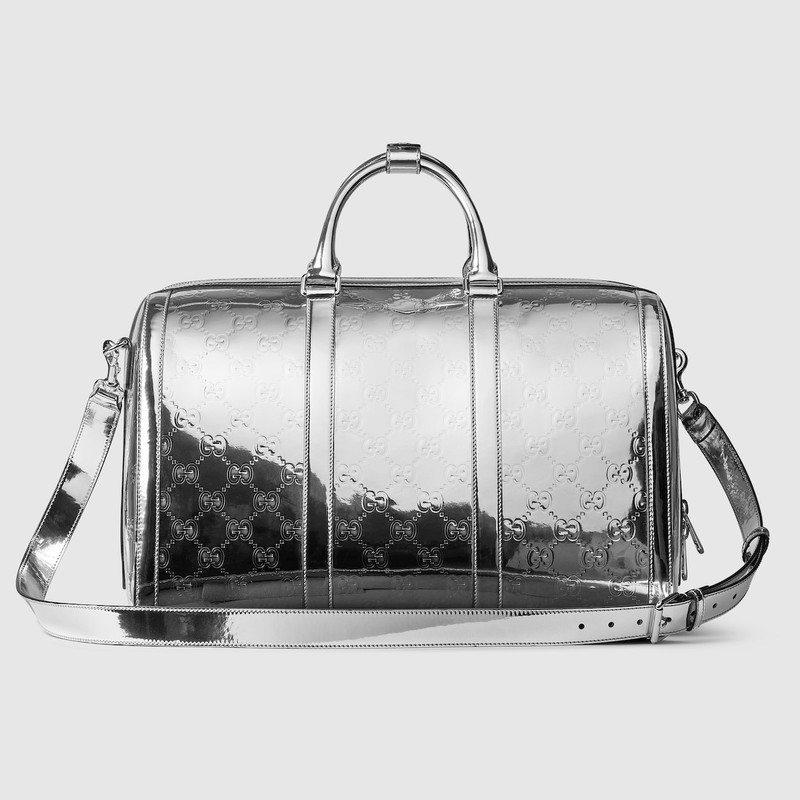 Medium embossed GG duffle bag 4