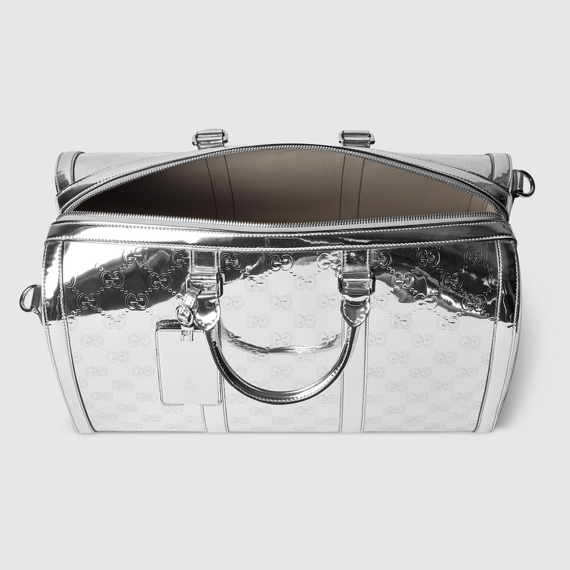 Medium embossed GG duffle bag 6