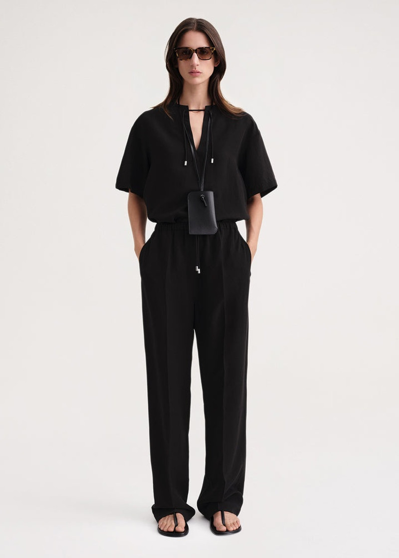 Totême Press-creased drawstring trousers black outlook
