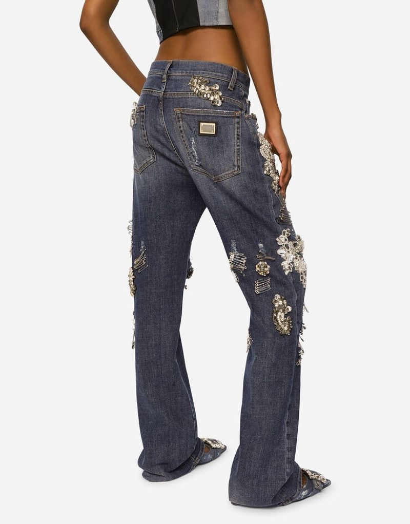Denim jeans with ripped details and appliqués 4