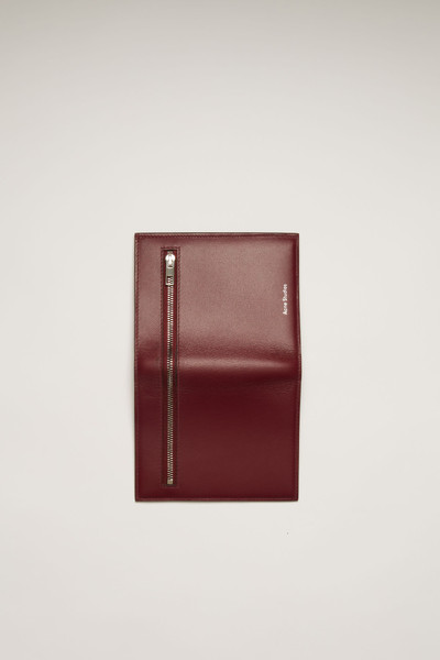 Acne Studios Trifold zip wallet burgundy outlook