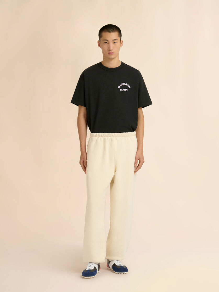 MARNI + MADHAPPY CREAM COTTON SWEATPANTS WITH ARCH LOGO PRINT - 2