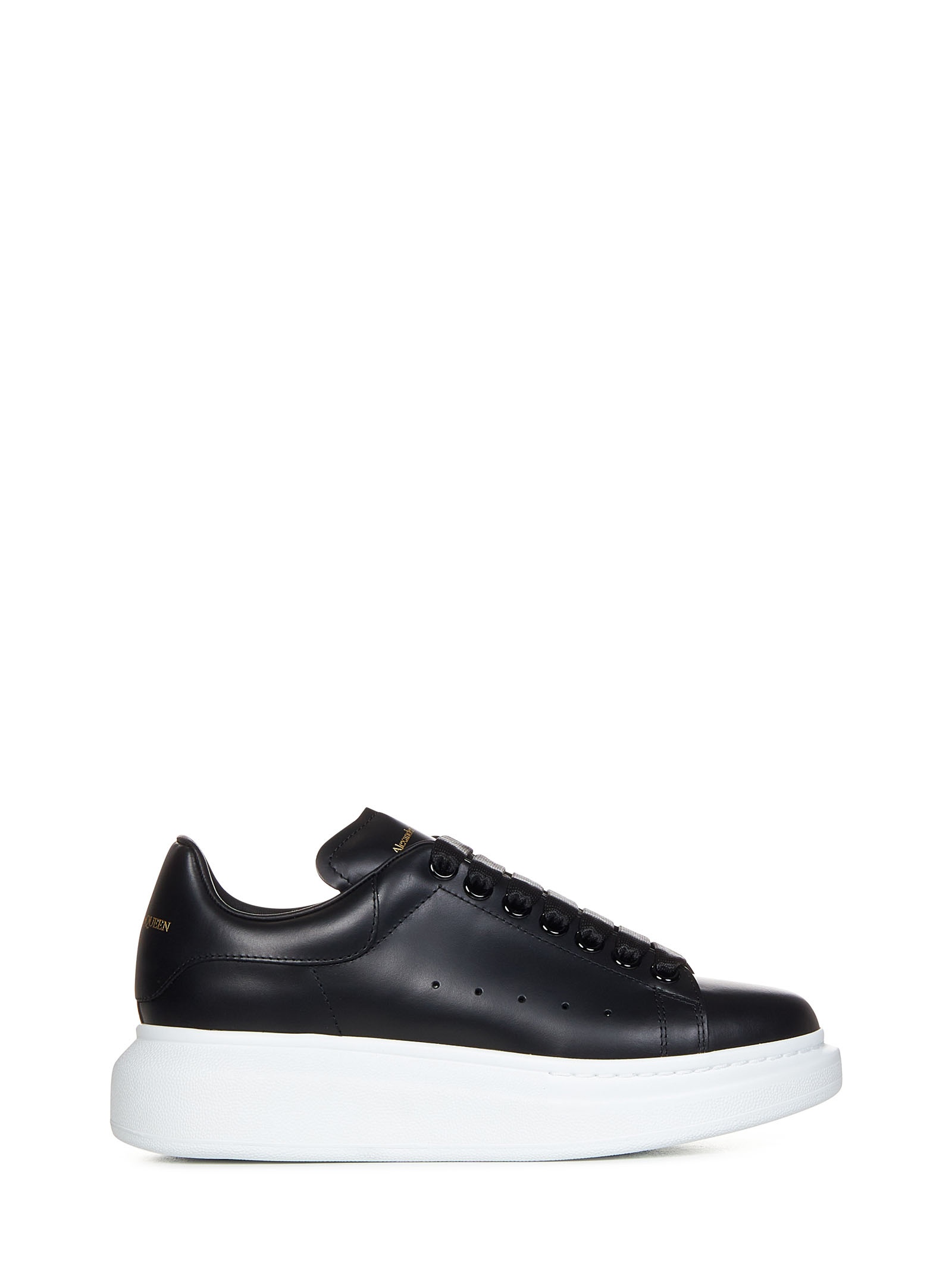 Black sneakers in smooth calfskin with oversized rubber sole and gold signature. - 1