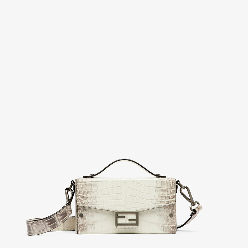 Small Baguette Soft Trunk made of exquisite crocodile leather in white with dark gray nuances. Flap  1