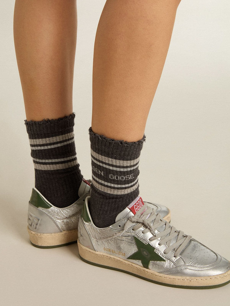 Dark grey socks with distressed details and cream and worn-white stripes 3