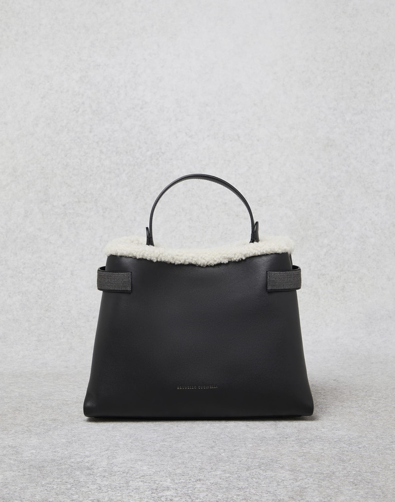 Matte calfskin bag with shearling trim and precious bands 1